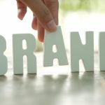 hand-arrange-white-letters-brand