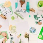 businesspeople-working-on-graph-with-various-natural-resources-icon-on-desk