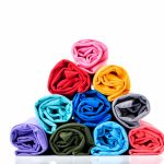 colorful-of-rolls-cotton-t-shirt-made-to-pyramid-shape-isolated-on-white-background