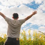 happy-man-nature-yellow-field-flower-bright-sky-white-cloud