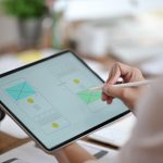 designer-using-tablet-planning-wireframe-mobile-website-ux-ui-app-development